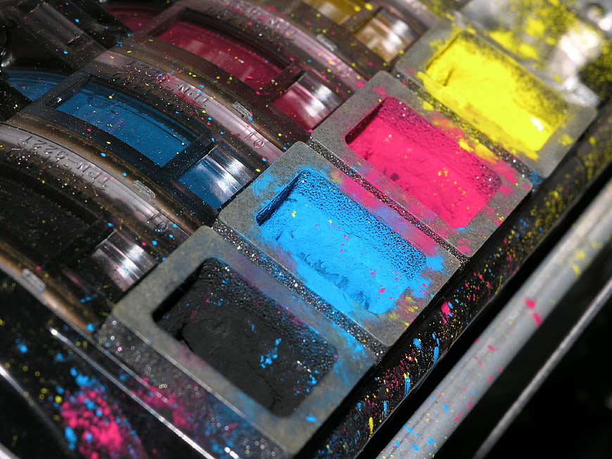 Close-up of colorful CMYK toner powder in a printer cartridge