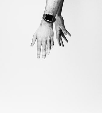 Black and white photo of hands with smartwatch