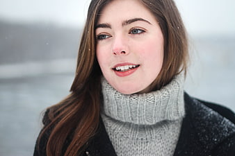 Portrait of smiling young woman in winter turtleneck sweater
