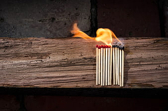 Burning Matches on Weathered Wooden Plank