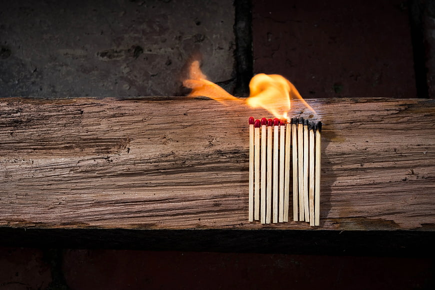 Burning Matches on Weathered Wooden Plank