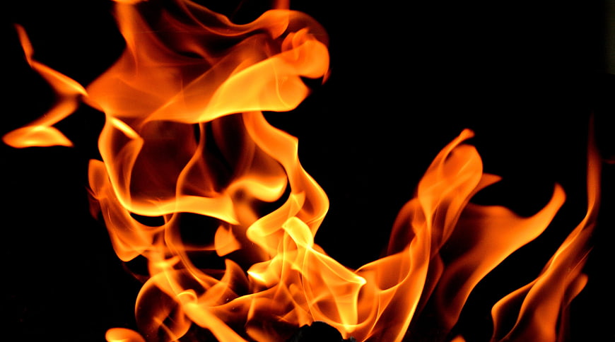 Vibrant orange flames rising against a solid black background