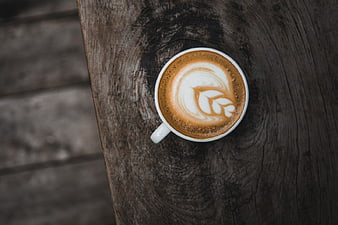 Top View Cappuccino with Latte Art on Rustic Wood