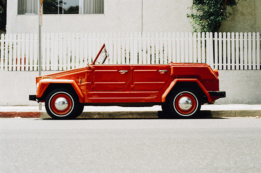 Vintage Red Convertible Car Parked on Street