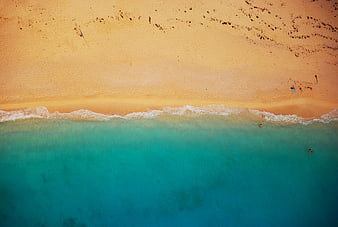Aerial View of Turquoise Ocean and Sandy Beach Shoreline