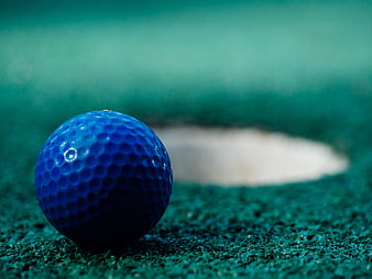 Blue Golf Ball on Green Turf Near Hole