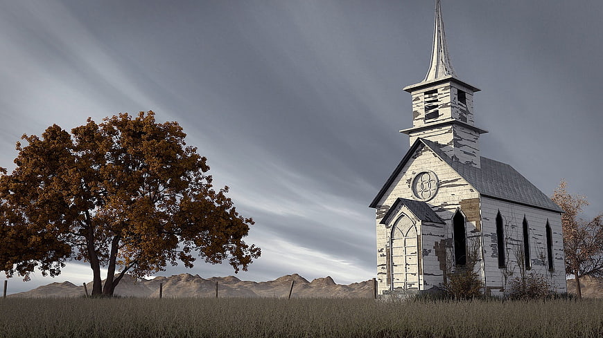 Abandoned white church in rural autumn landscape