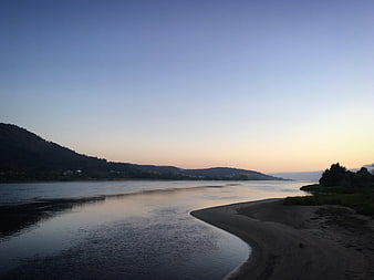 Serene River Landscape at Dusk with Sandy Shore