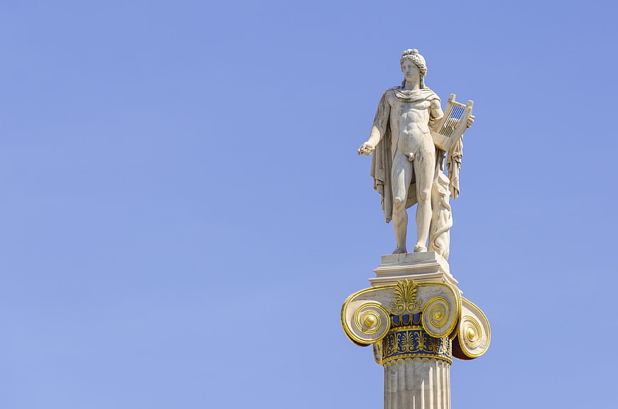 Apollo Statue on Ionic Column Against Clear Blue Sky