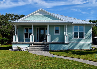 Light Blue Cottage with Metal Roof and Front Porch