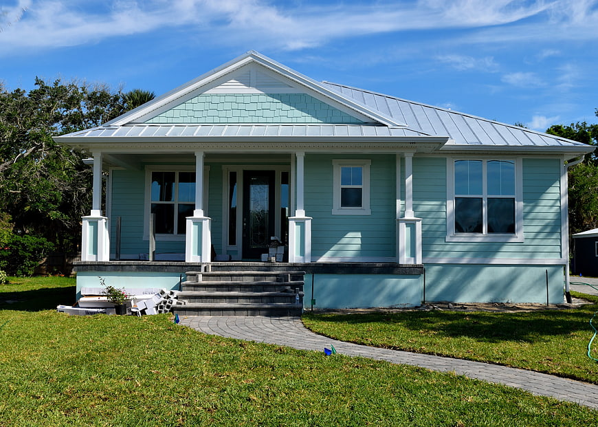 Light Blue Cottage with Metal Roof and Front Porch