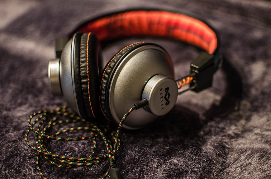 Silver and Orange Over-Ear Headphones on Furry Surface