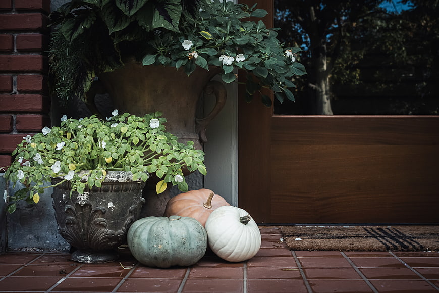 Autumn Pumpkins and Flowers on a Brick Porch