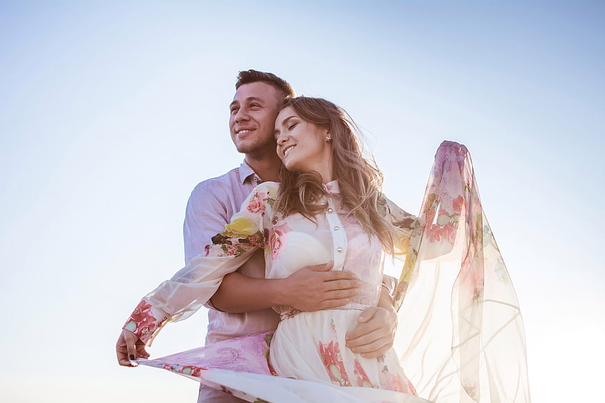 Romantic Young Couple Embracing Outdoors in Summer