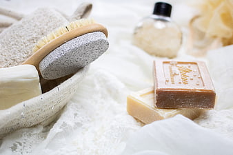 Natural handmade soaps and bath accessories on white linen