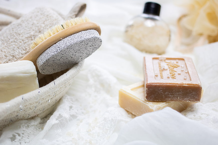 Natural handmade soaps and bath accessories on white linen