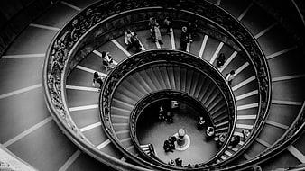 Black and white spiral staircase in Rome with people walking
