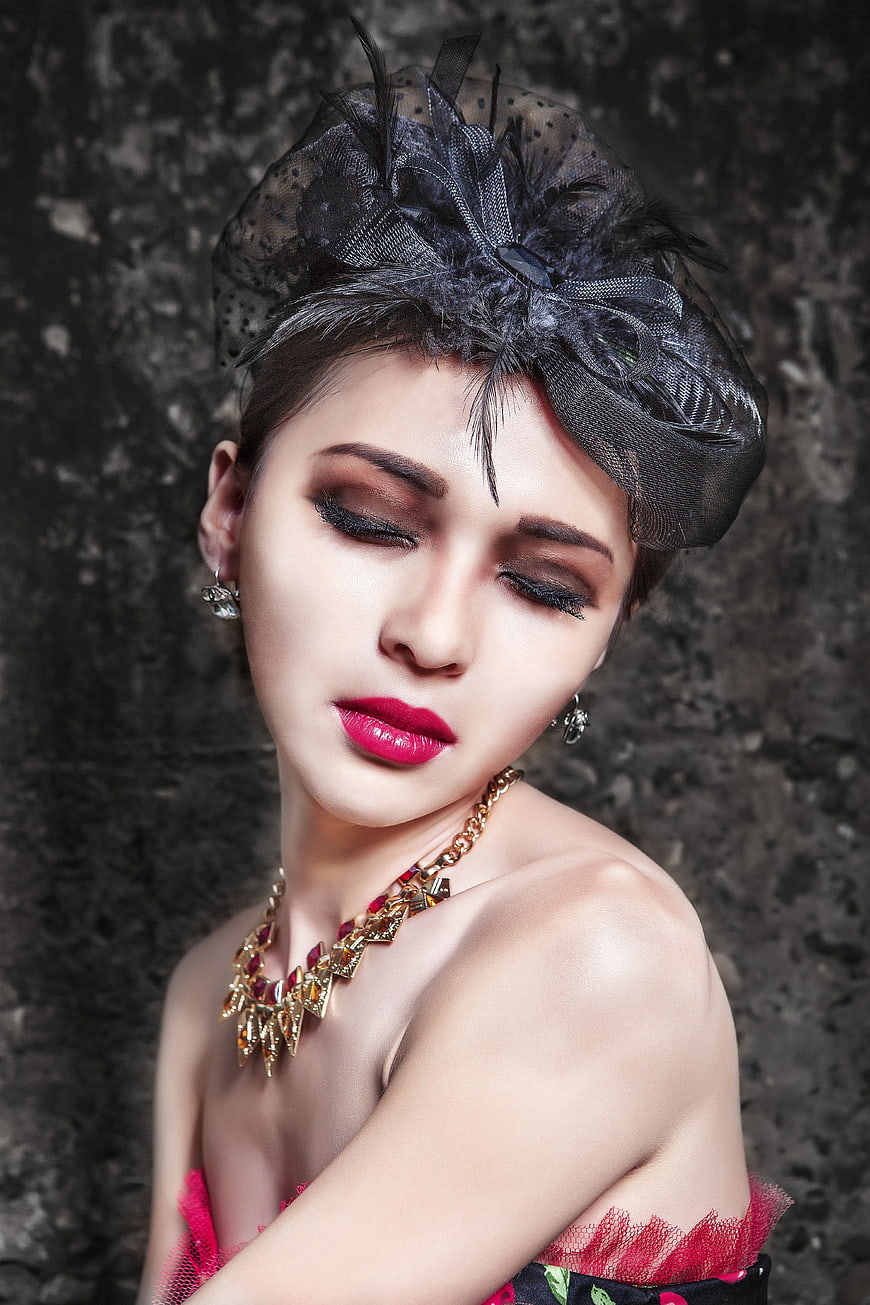 Elegant Woman with Black Fascinator and Bold Red Lipstick