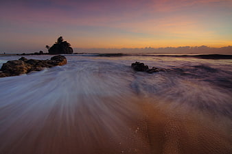 Long Exposure Sunset Ocean Waves Crashing on Rocky Beach
