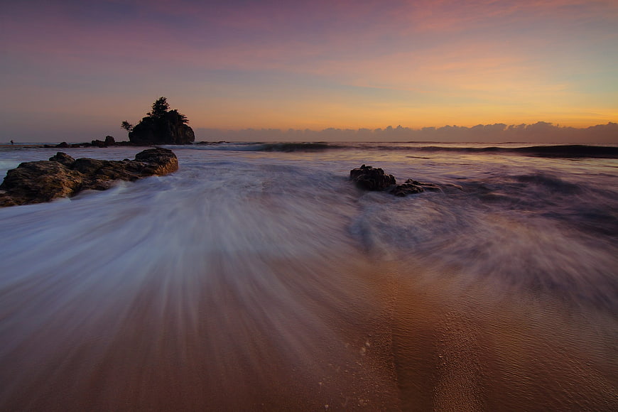 Long Exposure Sunset Ocean Waves Crashing on Rocky Beach