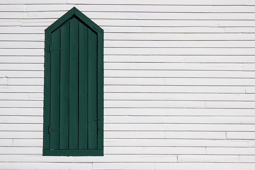 Green Wooden Door on White Siding Wall