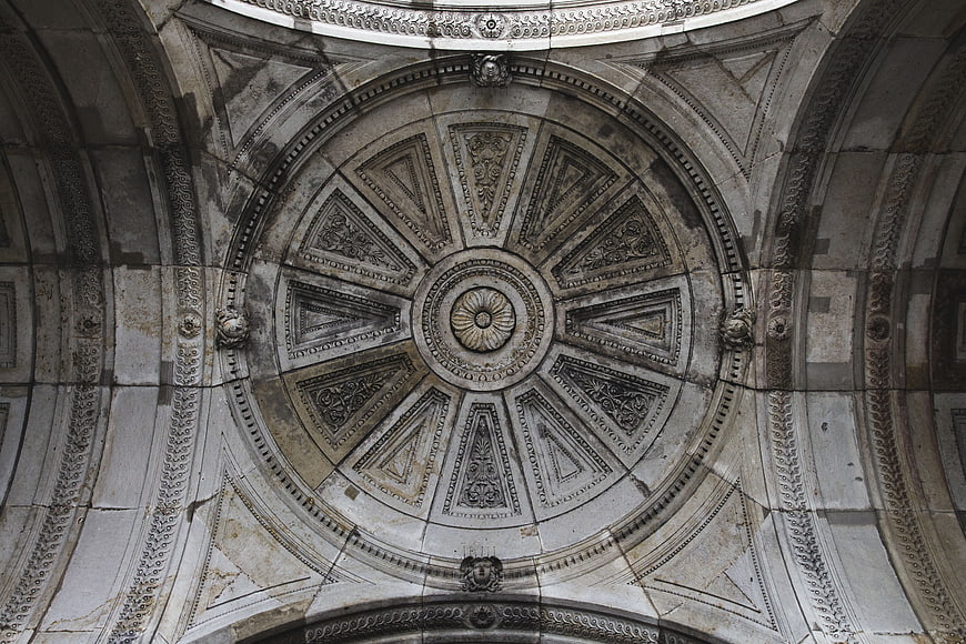 Ornate stone dome ceiling with intricate geometric carvings