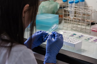 Scientist examining microscope slide in laboratory