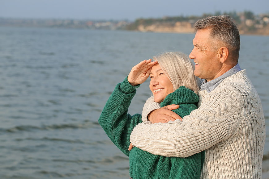 Happy Senior Couple Hugging by the Sea