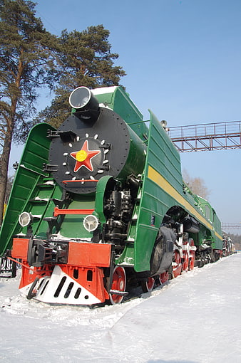 Vintage Green Steam Locomotive in Snowy Winter Landscape