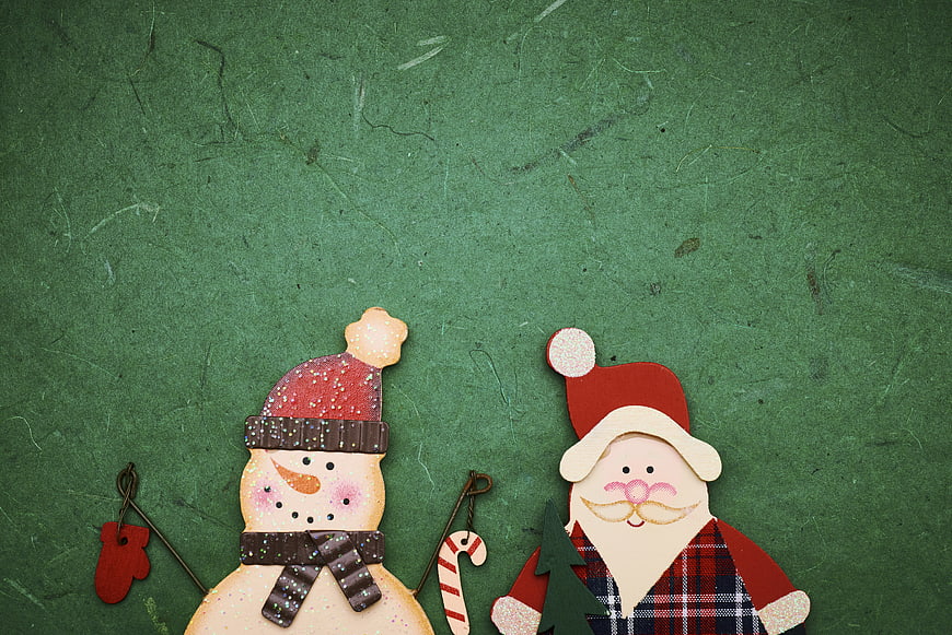 Wooden Santa and Snowman Christmas Ornaments on Green Background