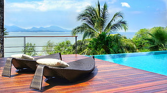 Luxury Tropical Resort Poolside With Wicker Loungers And Ocean View