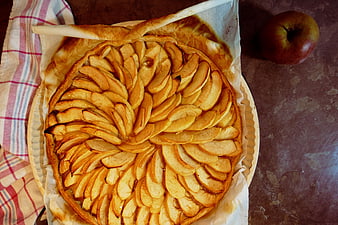 Rustic Apple Pie With Spiral Slices And Whole Apple On Table