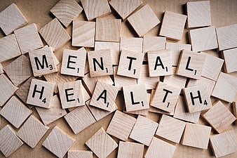 Mental Health spelled out with wooden Scrabble tiles