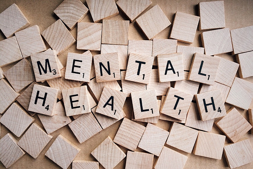 Mental Health spelled out with wooden Scrabble tiles
