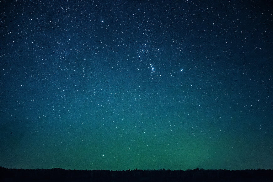 Starry Night Sky Over Dark Forest Silhouette