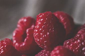 Close-up of fresh red raspberries with shallow depth of field