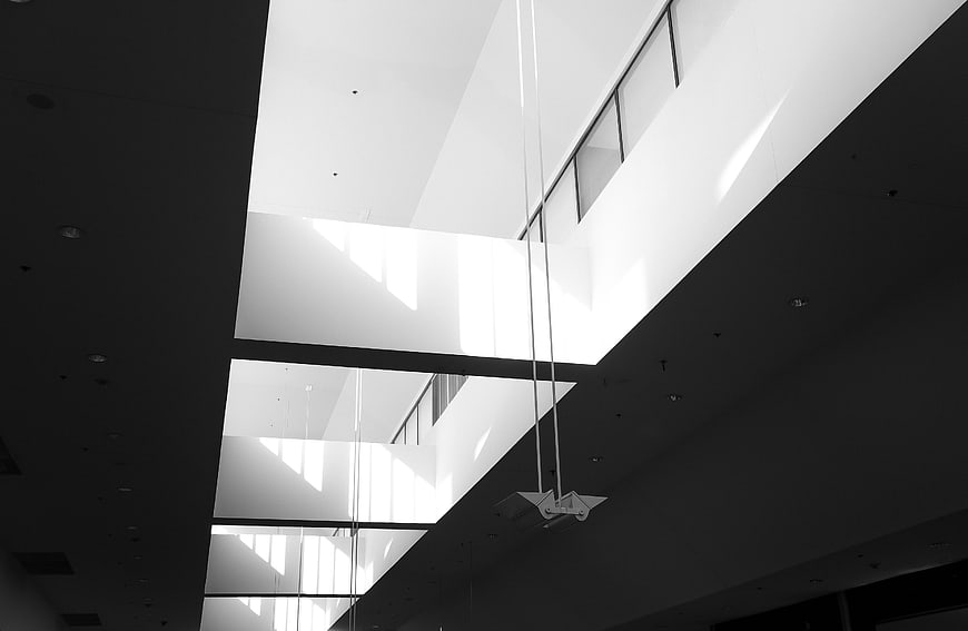 Modern black and white architectural interior with geometric light