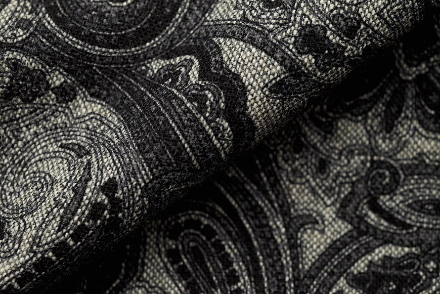 Close-up of black and white paisley woven fabric texture