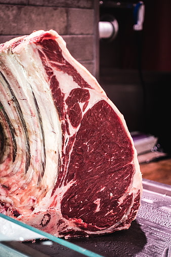 Close-up of raw beef ribeye steak with bone