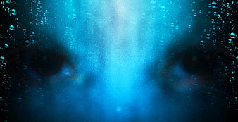 Spooky Blue Eyes Peeking Through Water Bubbles