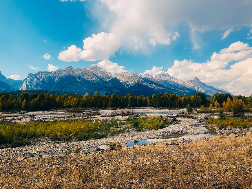 Scenic Wyoming Mountain Landscape with River and Autumn Trees