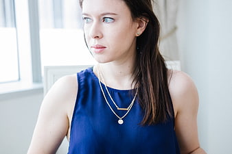 Portrait of a woman in a blue dress looking away