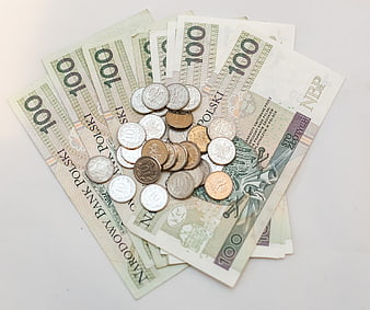 Pile of Polish 100 Zloty Banknotes and Coins on White Background