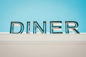 Retro Diner Sign Against Blue Sky