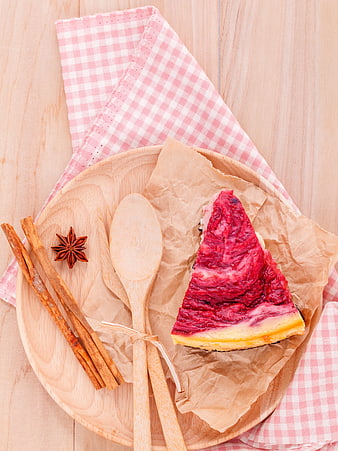 Slice of Beetroot Cake on Wooden Plate with Cinnamon and Star Anise