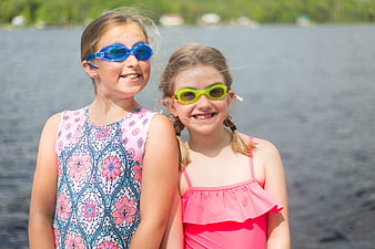 Two Happy Girls in Swimsuits and Goggles by Lake