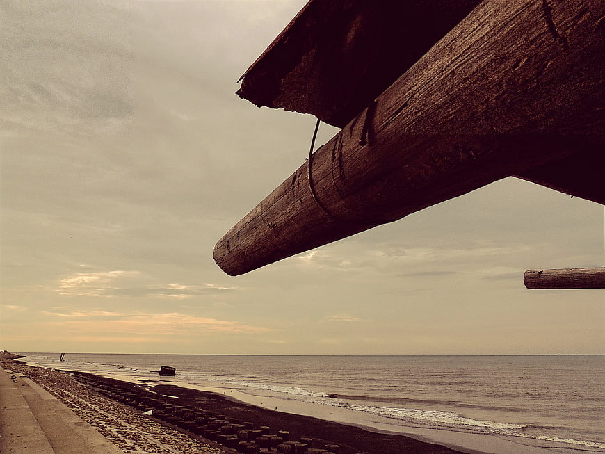 Weathered wooden beam framing a moody Black Sea coastline