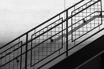 Black and white geometric staircase railing shadows