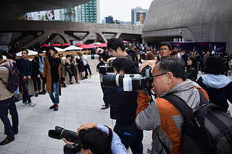 Photographers with DSLR Cameras at Outdoor Event
