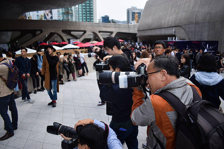 Photographers with DSLR Cameras at Outdoor Event